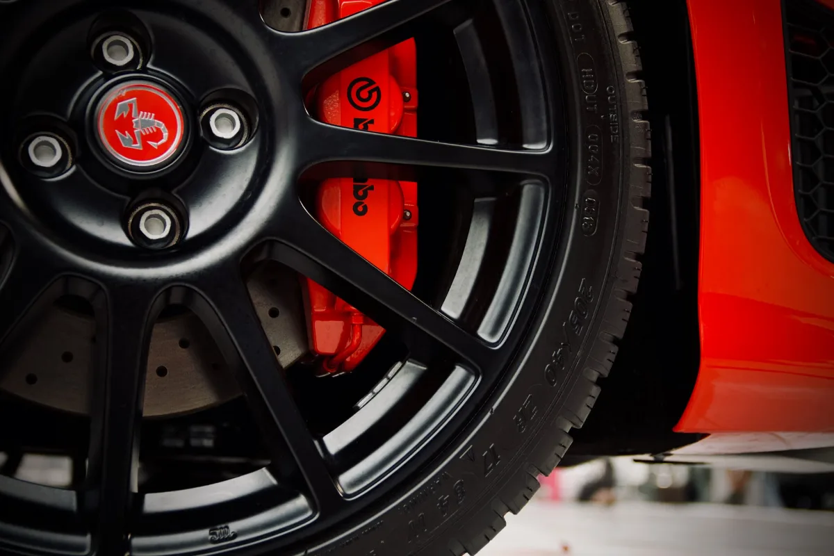 Detailed view of a black wheel and red Brembo brake on a sports car