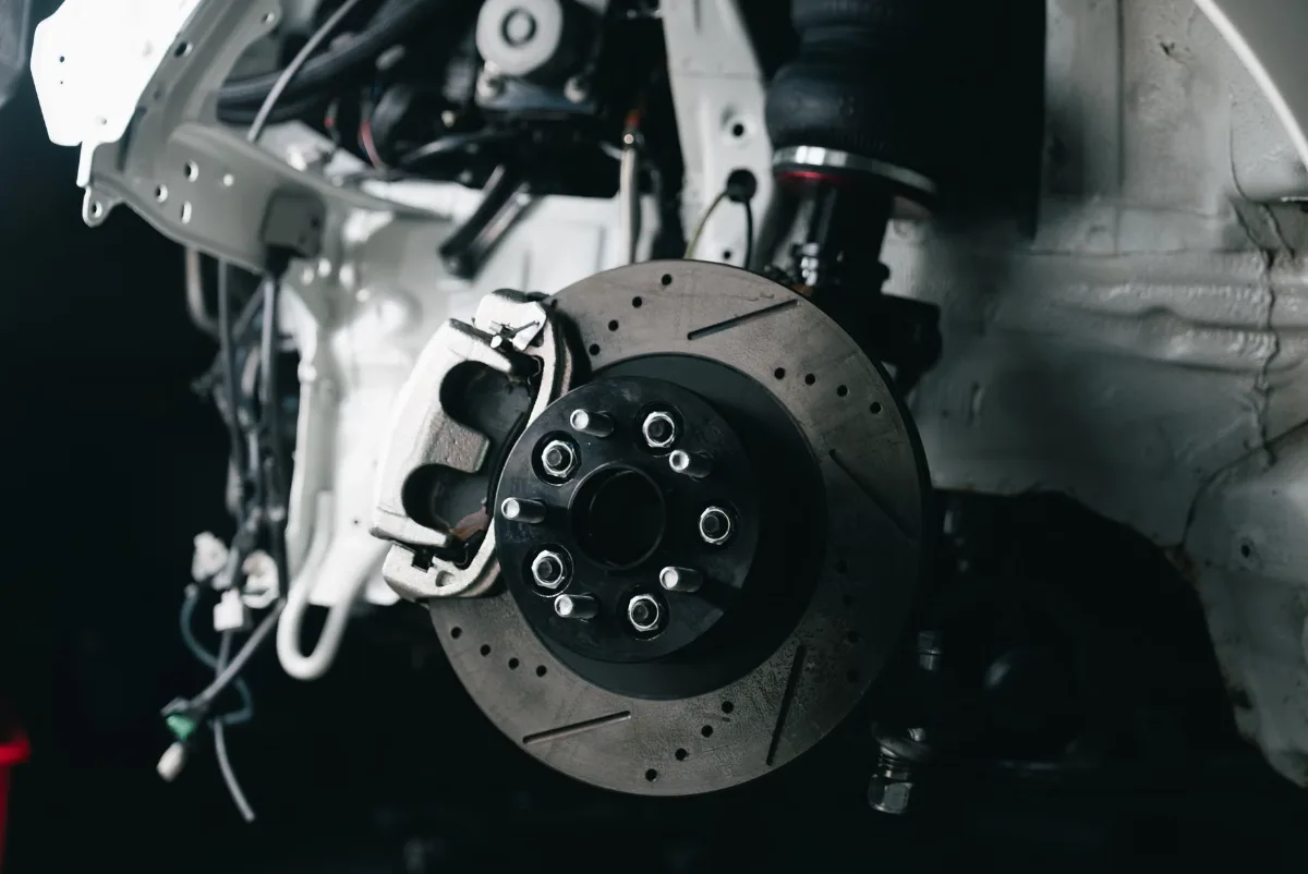 Close-up of a disc brake, caliper and the flexible brake hose at the wheel