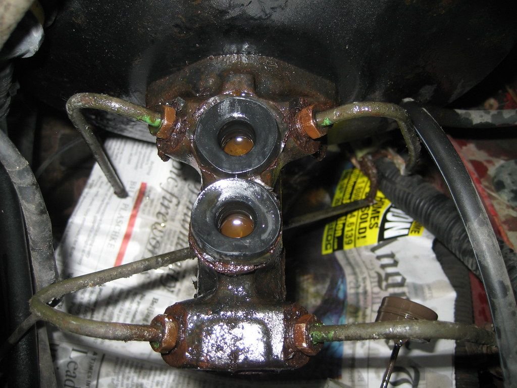 Old brake master cylinder with brake lines attached, removed during a brake master cylinder replacement