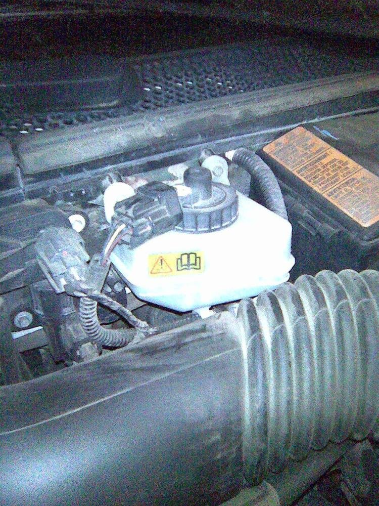 Brake fluid reservoir under the hood, checked first before paying for a brake master cylinder replacement