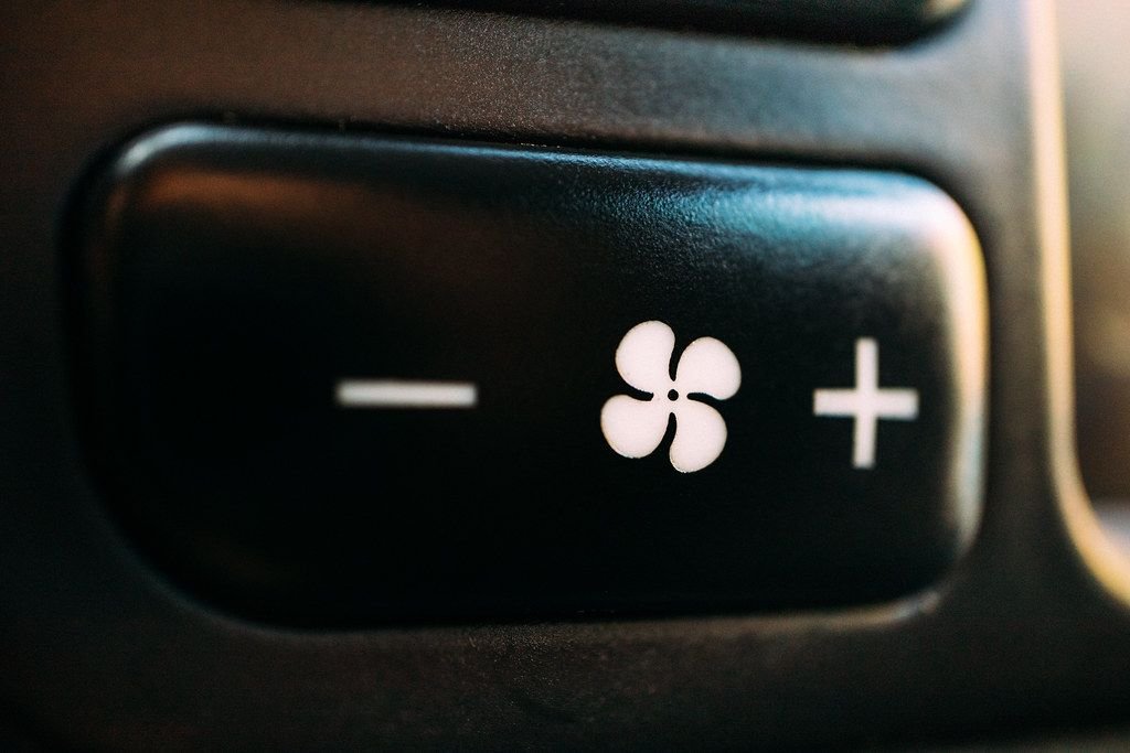 Car air conditioning fan speed button, where weak or warm airflow is often the first sign of an AC leak