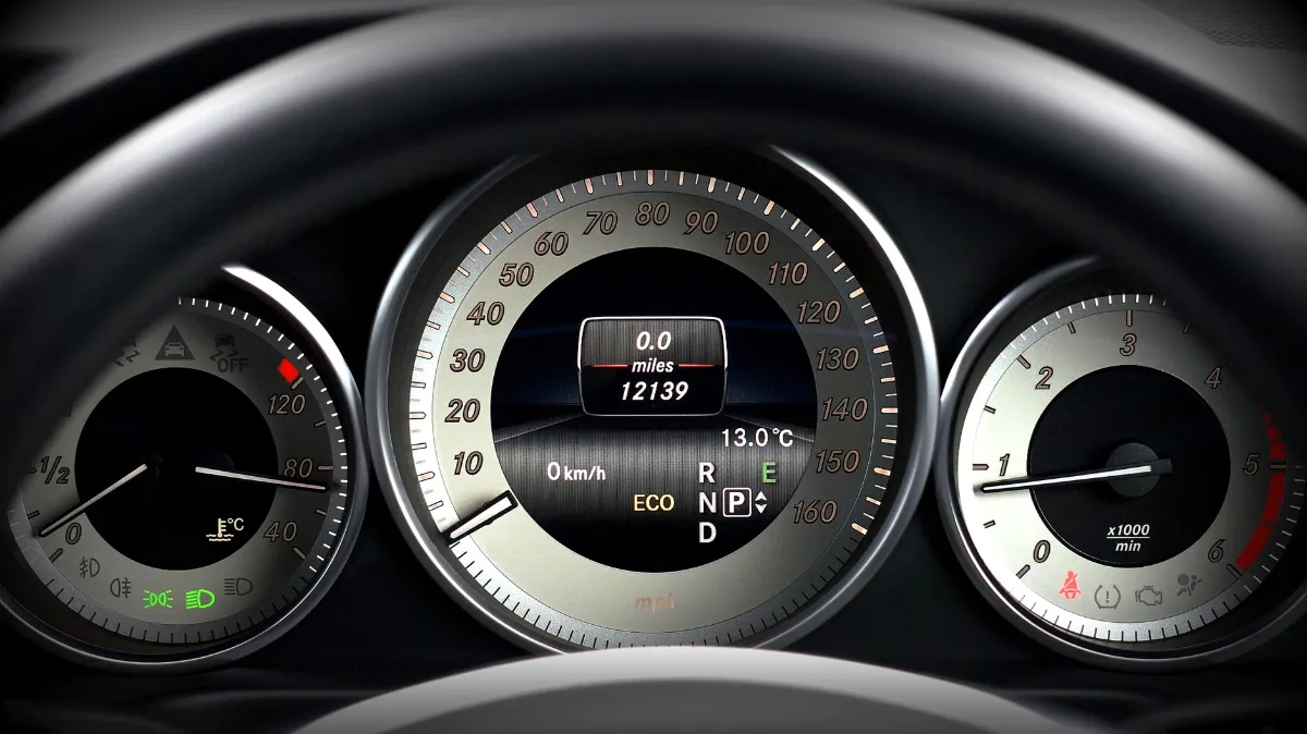 Close-up image of a car dashboard highlighting speedometer, odometer, and temperature gauge