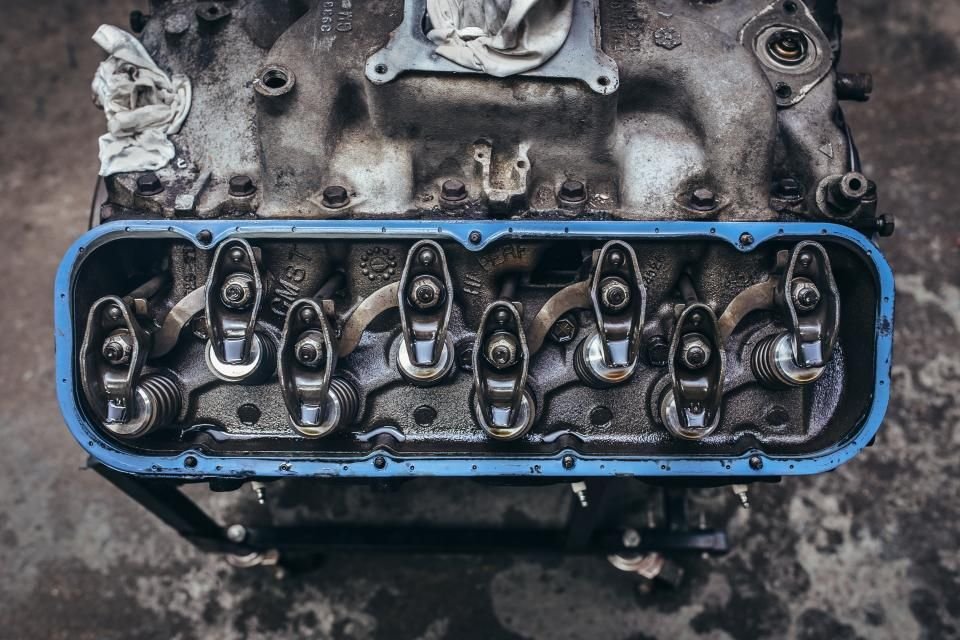 Engine cylinder head with valves exposed during a teardown, showing why engine failure is costly and not covered by gap insurance