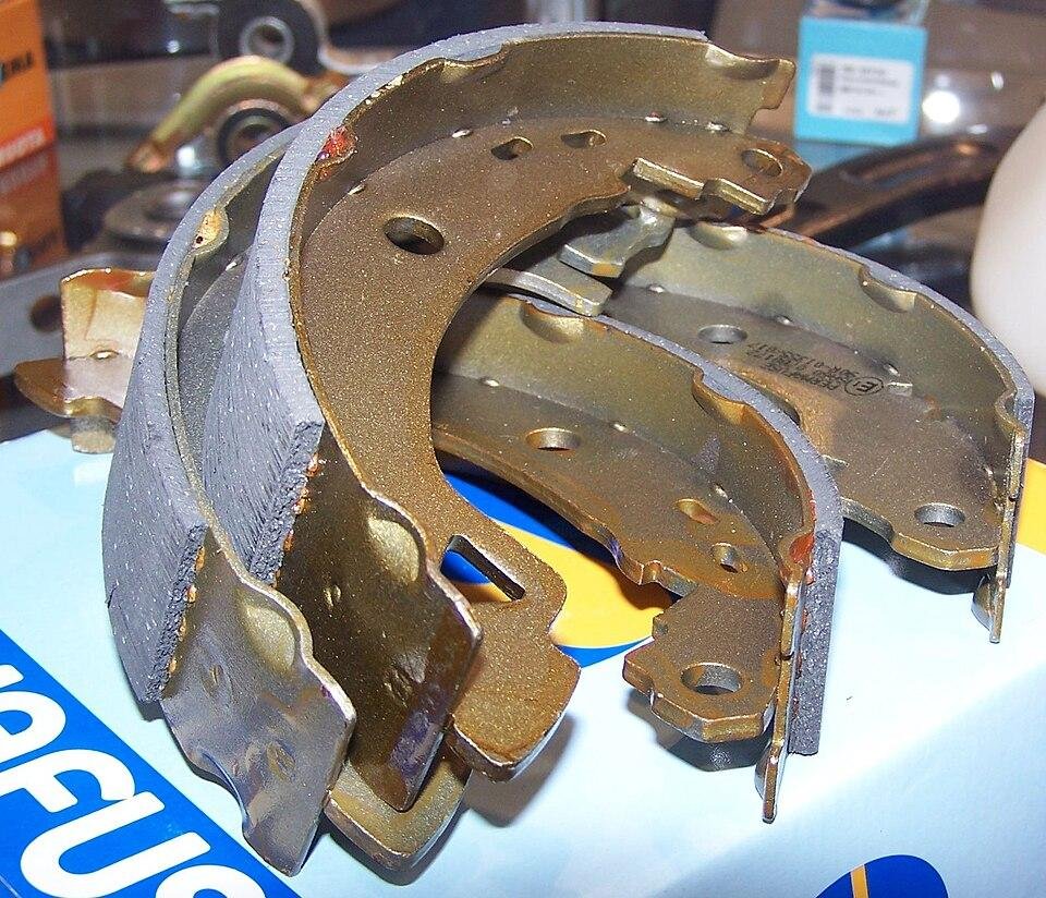 Set of new drum brake shoes showing the friction lining, the main part inside a drum brake