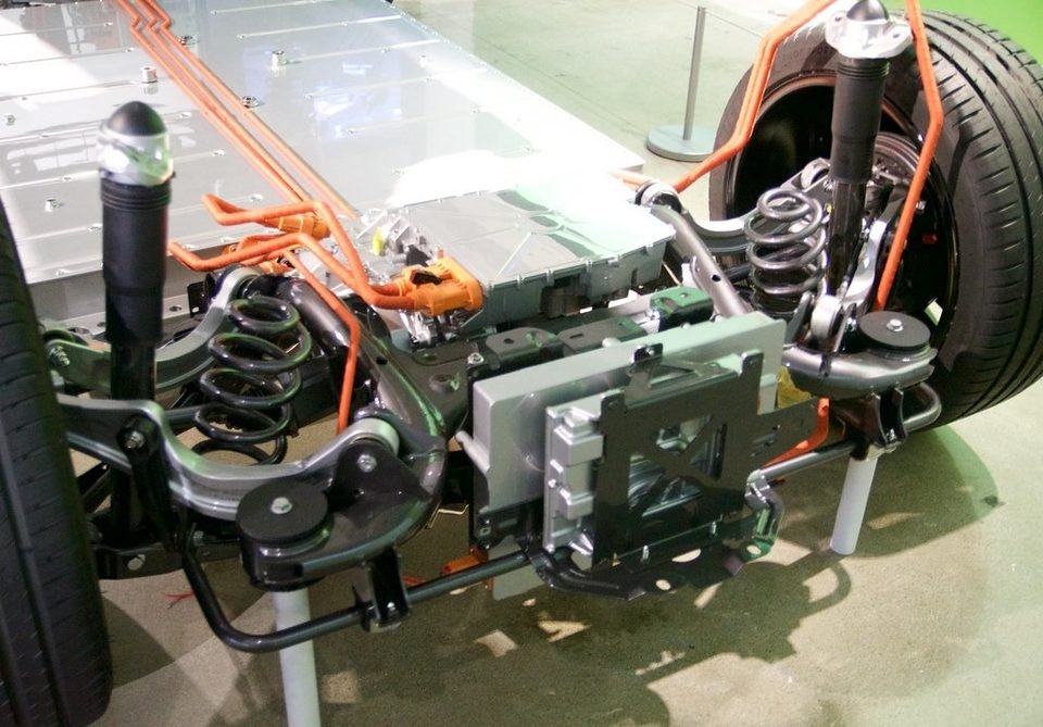 Exposed car chassis showing the front strut and coil spring assembly