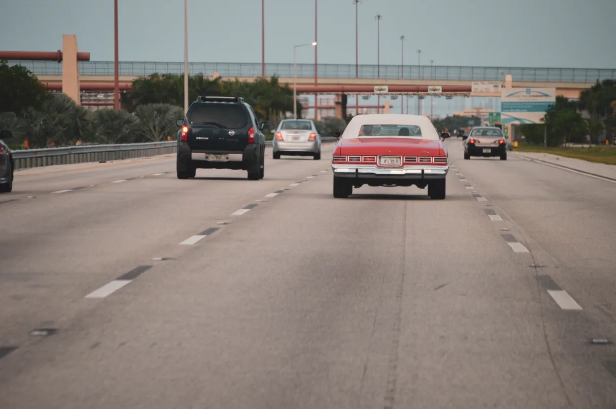 Highway traffic scene with classic car in Miami, Florida, showcasing urban travel atmosphere