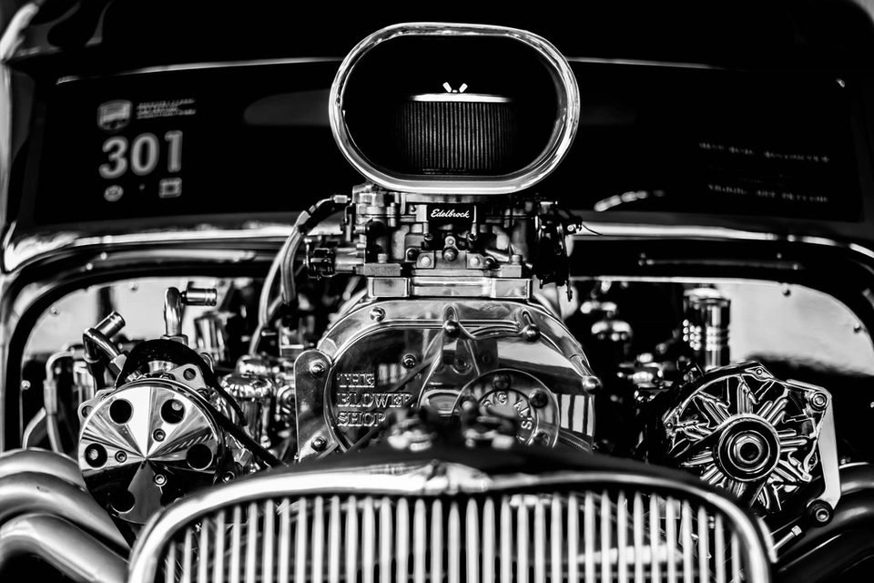 Classic car engine bay behind the grille, where the radiator sits at the front of the cooling system