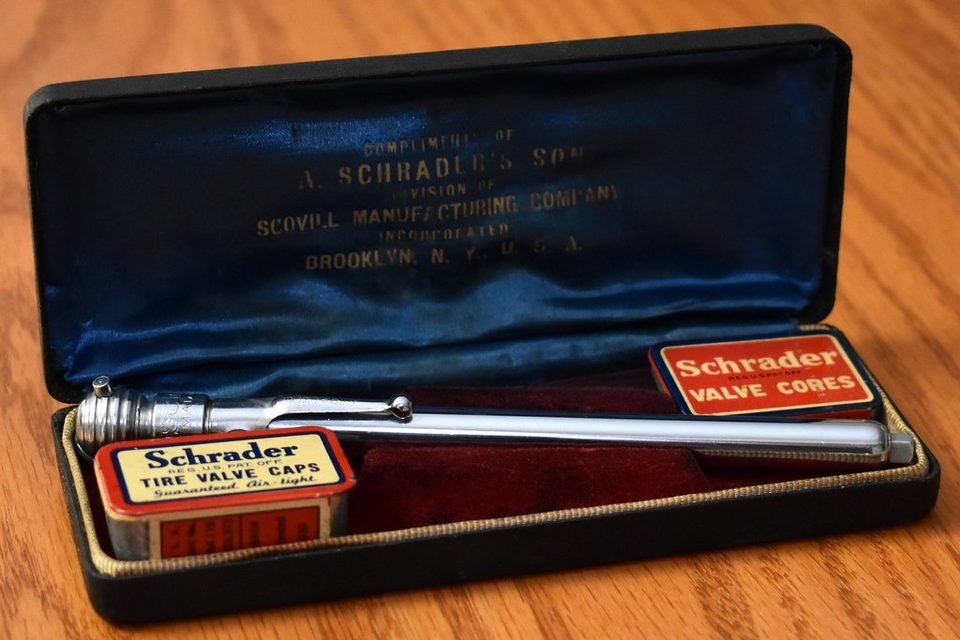 Tire pressure gauge and Schrader valve cores, the same valve type used by many TPMS sensors